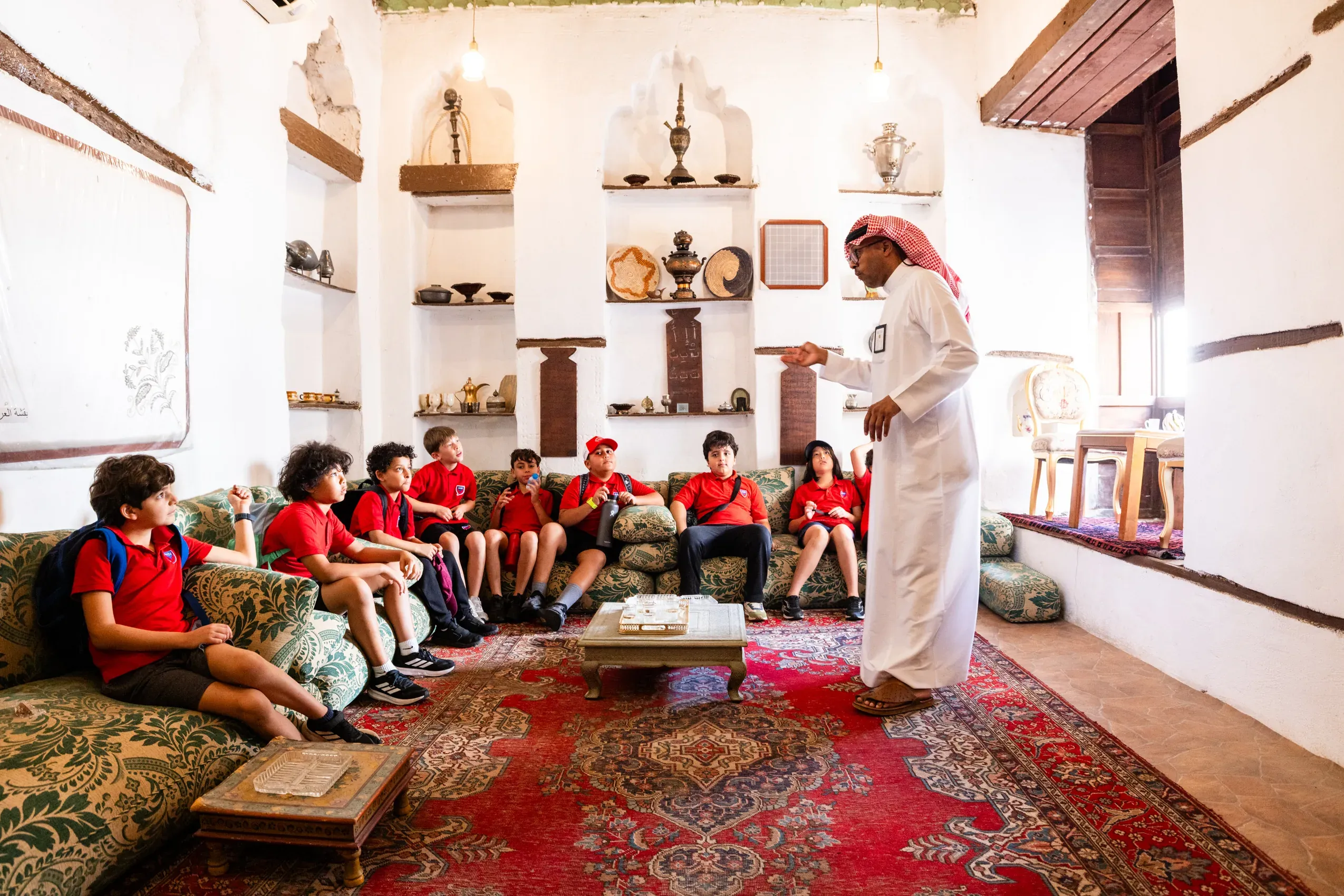 AISJ elementary students learning from a guide during an Al-Balad field trip